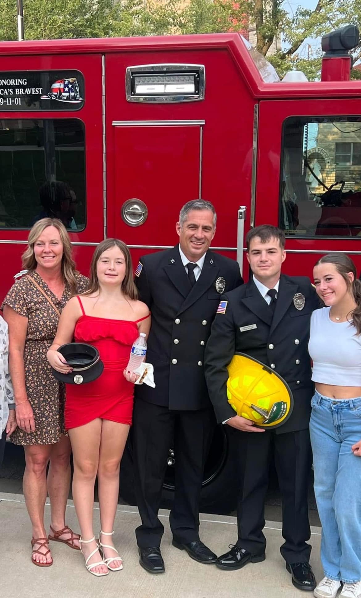 Captain Brian Williams in KCKFD dress uniform with his wife, daughters, and son at his son's fire academy graduation